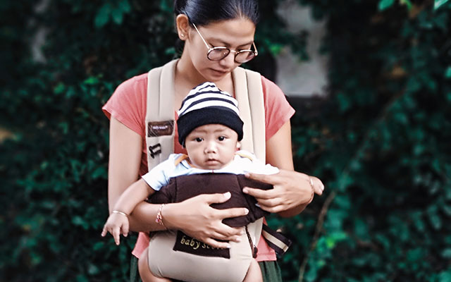 A mother with her son in a baby bjorn