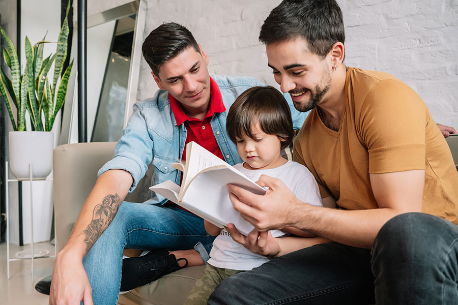 Two men reading to a child